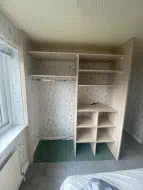 Lakeland Acacia shelving and hanging leaving room for a tv, installed in Fairfield